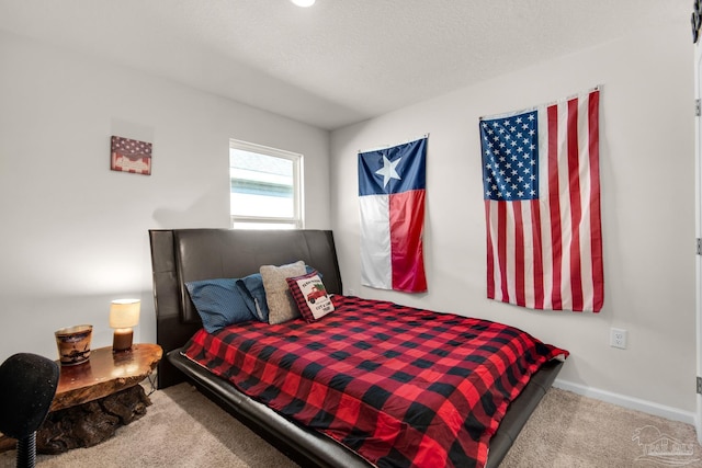 carpeted bedroom featuring a textured ceiling