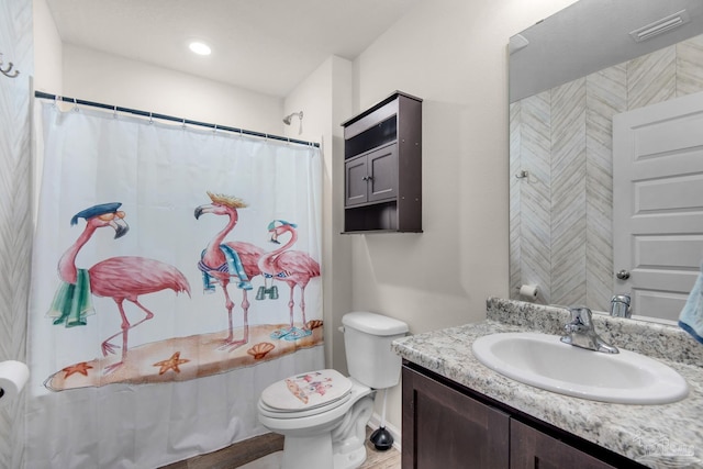 bathroom with a shower with curtain, vanity, and toilet