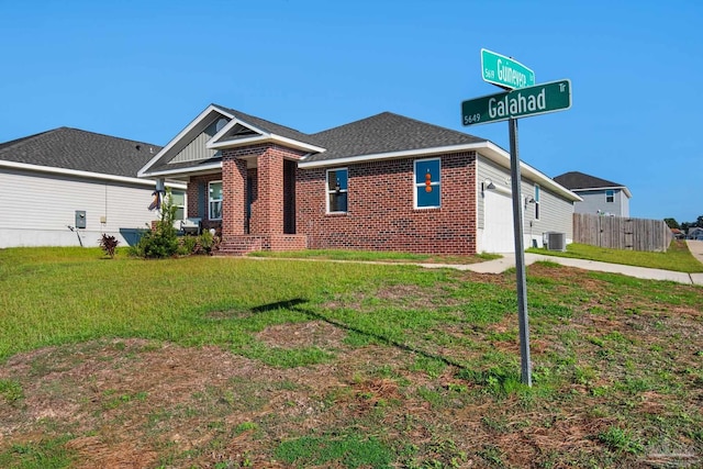 view of front facade with central air condition unit, a garage, and a front lawn