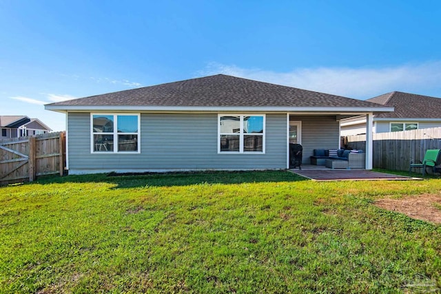 rear view of property featuring a patio, a yard, and an outdoor hangout area