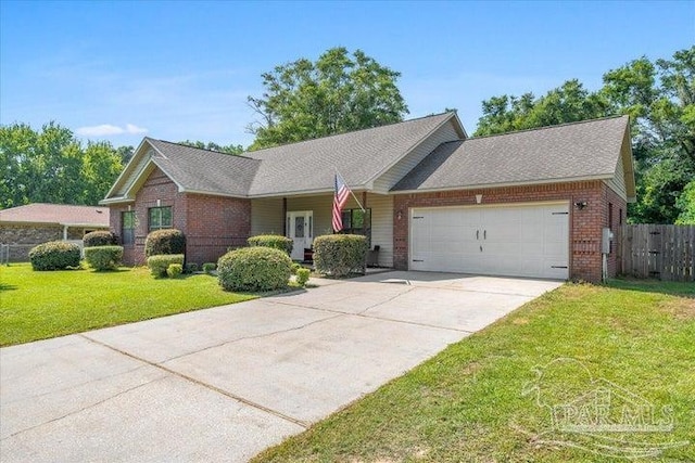 single story home featuring a garage and a front yard