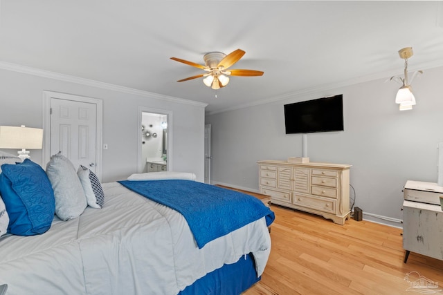 bedroom featuring light wood-type flooring, ensuite bath, baseboards, and crown molding