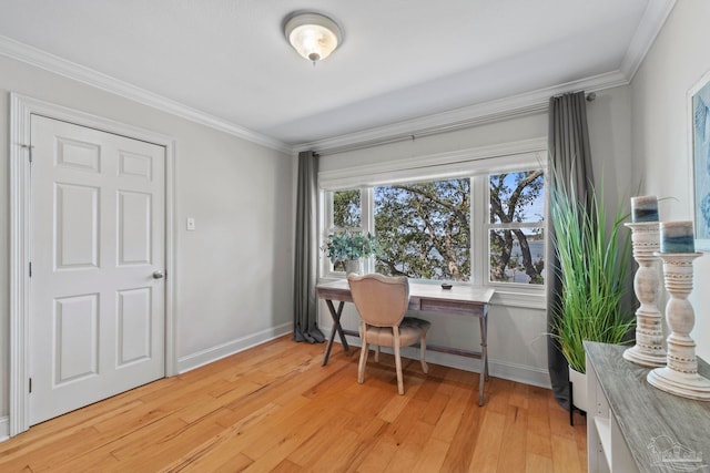 office space with baseboards, light wood-type flooring, and crown molding