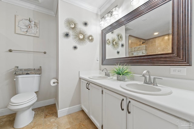 bathroom with toilet, crown molding, baseboards, and a sink