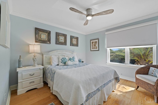 bedroom with light wood-style flooring, baseboards, ceiling fan, and crown molding