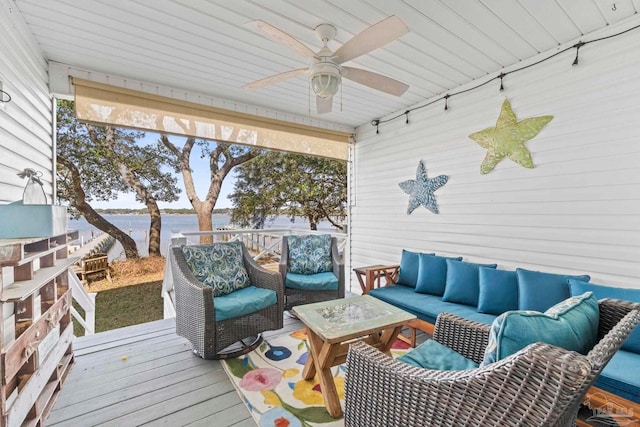 wooden deck featuring outdoor lounge area, ceiling fan, and a water view