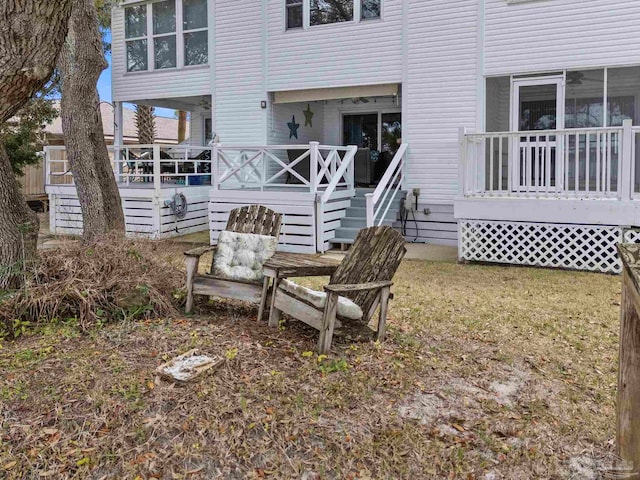 rear view of house featuring a wooden deck