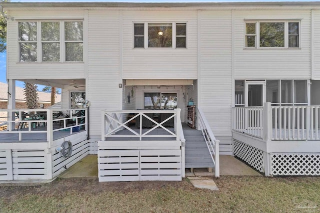 rear view of house with a sunroom and a deck