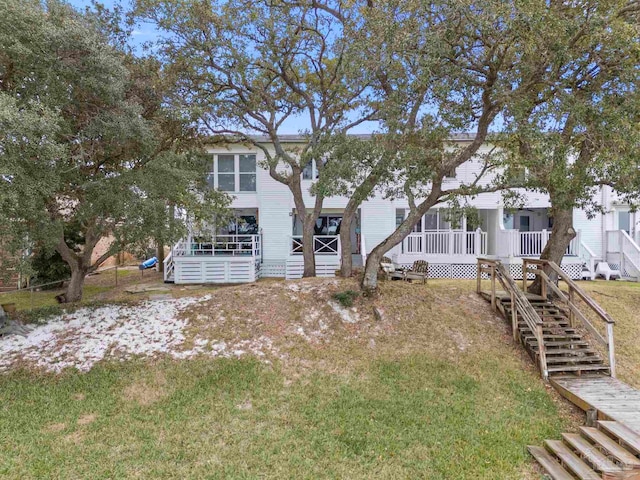 view of front of home with a front yard and stairway