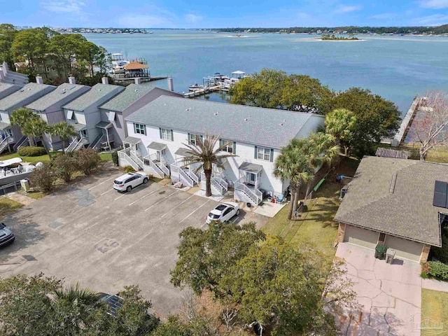 drone / aerial view with a water view and a residential view