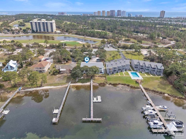 birds eye view of property featuring a water view and a city view