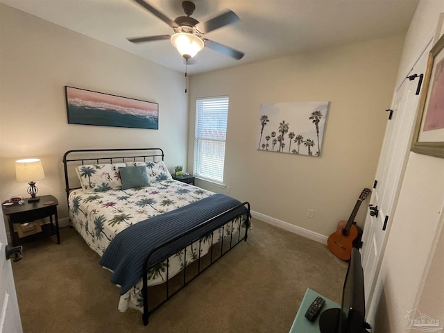 carpeted bedroom featuring baseboards and a ceiling fan