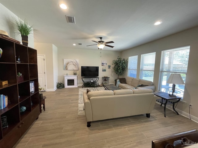 living area with baseboards, recessed lighting, light wood-style flooring, and ceiling fan