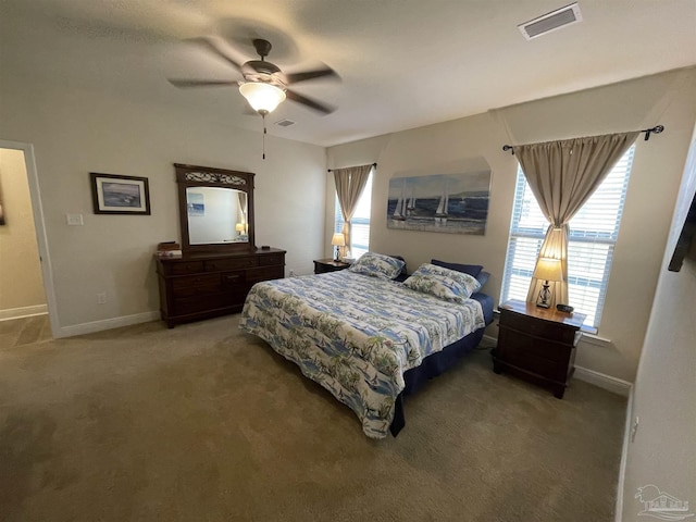 carpeted bedroom with baseboards, a ceiling fan, and visible vents