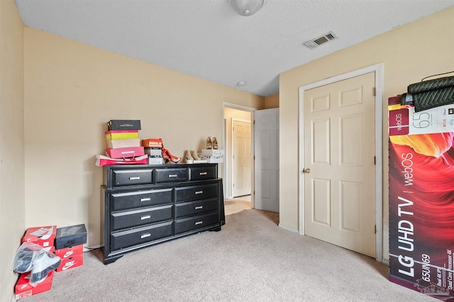 carpeted bedroom with a textured ceiling