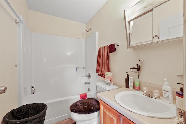 full bathroom featuring a textured ceiling, shower / washtub combination, vanity, and toilet