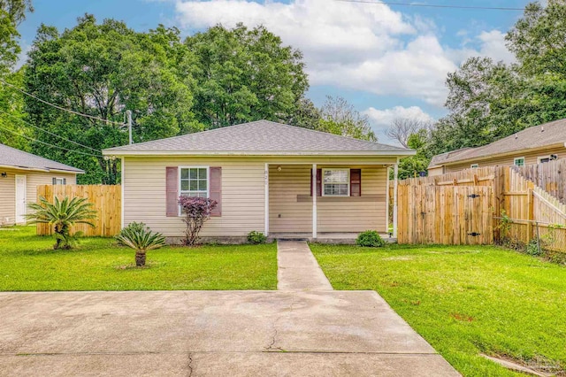 bungalow featuring a patio and a front lawn