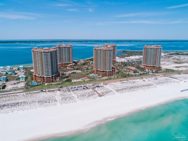 birds eye view of property with a water view and a view of the beach