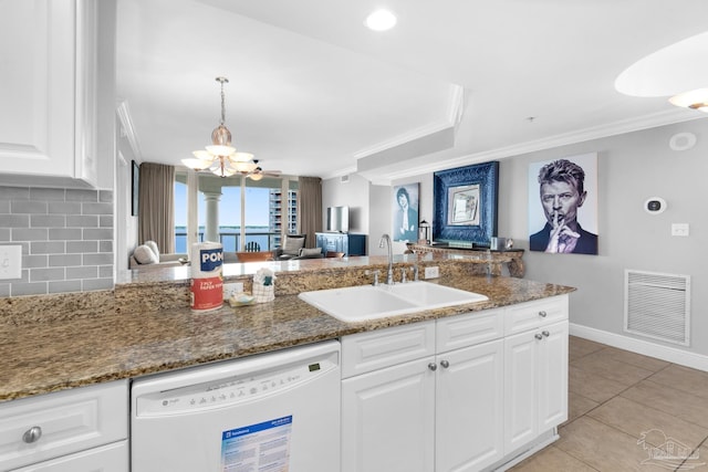 kitchen featuring white cabinetry, sink, dark stone countertops, backsplash, and white dishwasher