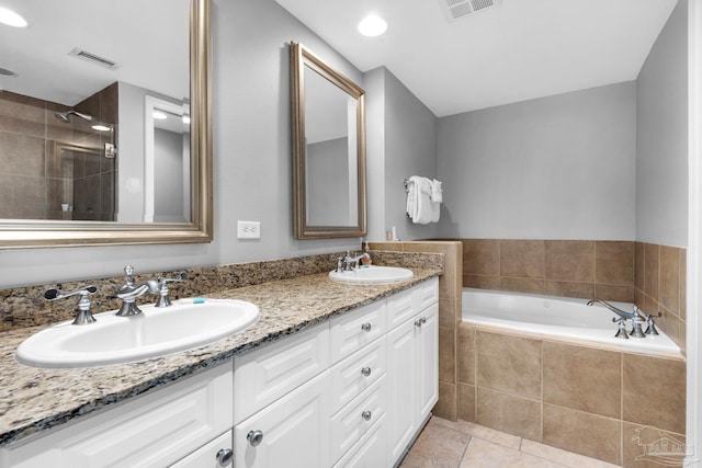 bathroom featuring vanity, tile patterned floors, and shower with separate bathtub