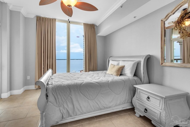 tiled bedroom featuring crown molding, ceiling fan, and a water view