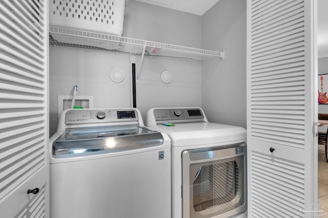 clothes washing area with washing machine and clothes dryer