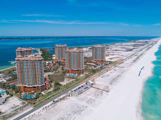 bird's eye view with a water view and a beach view