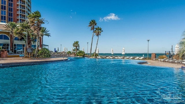 view of swimming pool featuring a water view