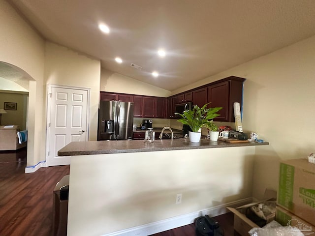 4955 Makenna Cir, Pace, FL 32571 - kitchen featuring appliances with stainless steel finishes, vaulted ceiling, arched walkways, dark countertops, and a peninsula