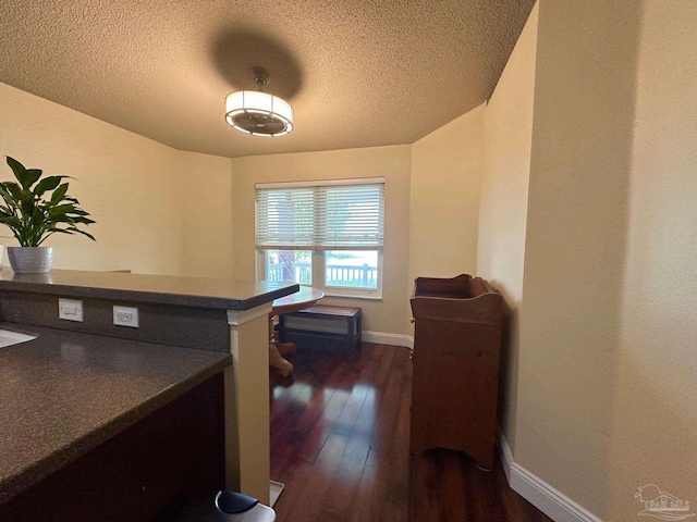 4955 Makenna Cir, Pace, FL 32571 - office with dark wood-type flooring, baseboards, and a textured ceiling