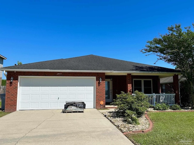 4955 Makenna Cir, Pace, FL 32571 - ranch-style house featuring brick siding, concrete driveway, a porch, and a garage
