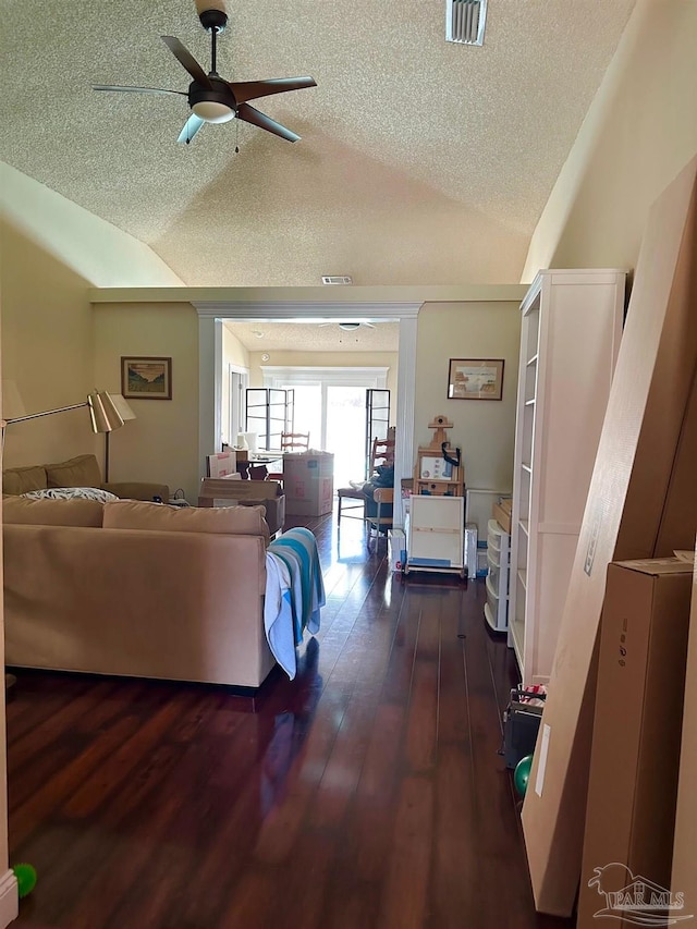 4955 Makenna Cir, Pace, FL 32571 - living room featuring lofted ceiling, a textured ceiling, ceiling fan, and dark wood-style floors