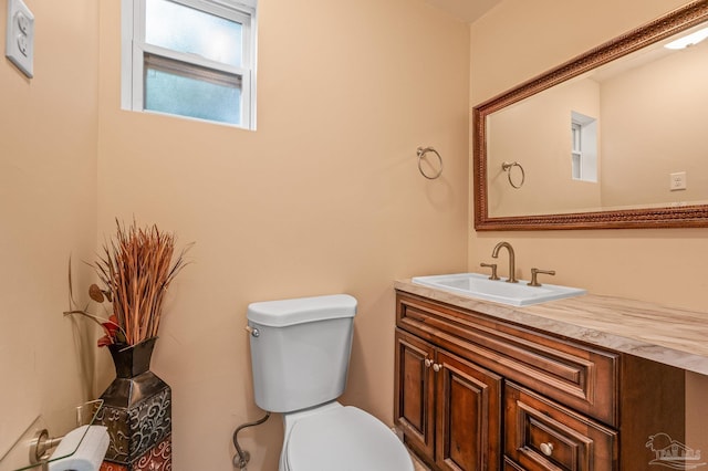 half bathroom with toilet and vanity