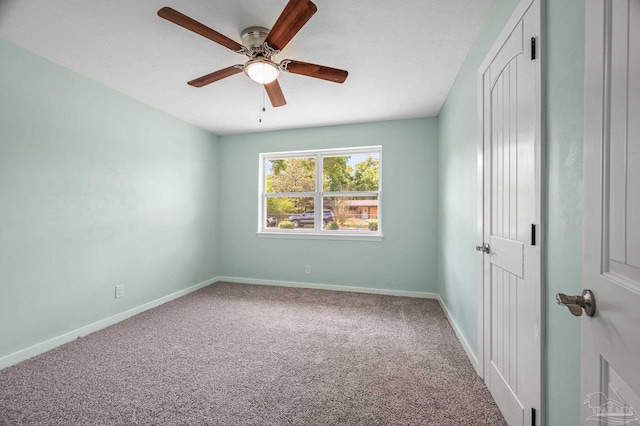unfurnished bedroom with carpet flooring, baseboards, and ceiling fan