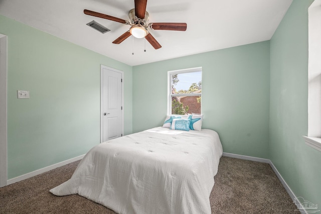 carpeted bedroom with baseboards, visible vents, and ceiling fan