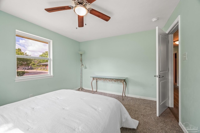 carpeted bedroom featuring a ceiling fan and baseboards
