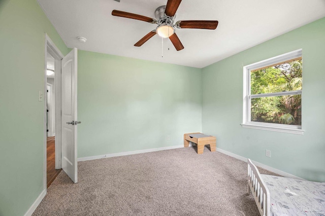 unfurnished bedroom with carpet floors, baseboards, and ceiling fan