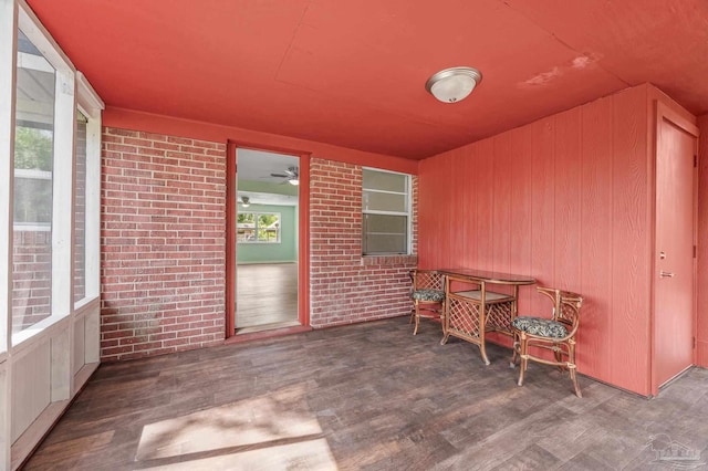 sunroom featuring ceiling fan