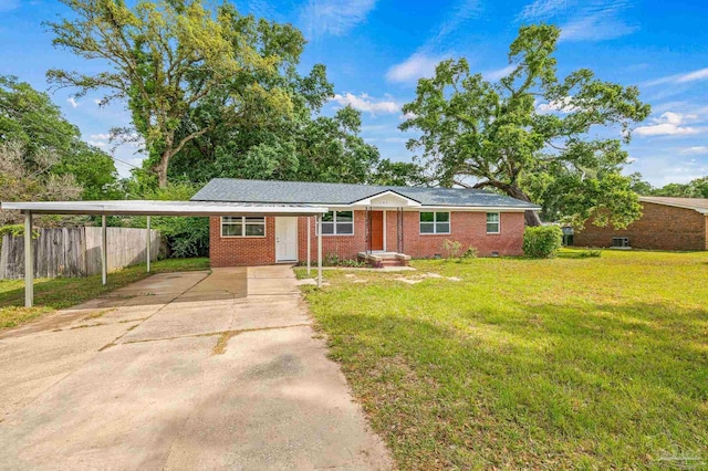 ranch-style home featuring brick siding, fence, driveway, and a front yard