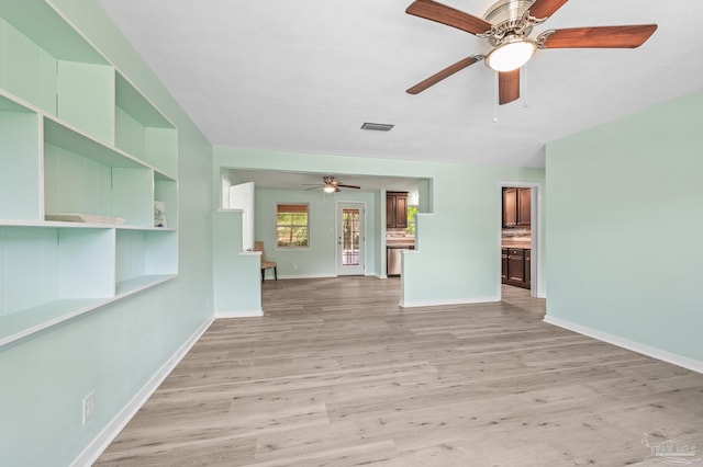 unfurnished living room with visible vents, a ceiling fan, baseboards, and light wood finished floors