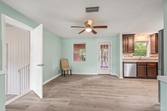 kitchen featuring ceiling fan, light countertops, stainless steel appliances, light wood-type flooring, and visible vents