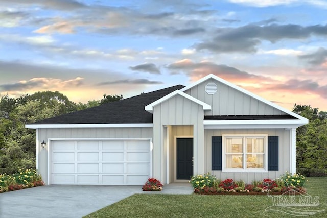 view of front of property with a lawn and a garage