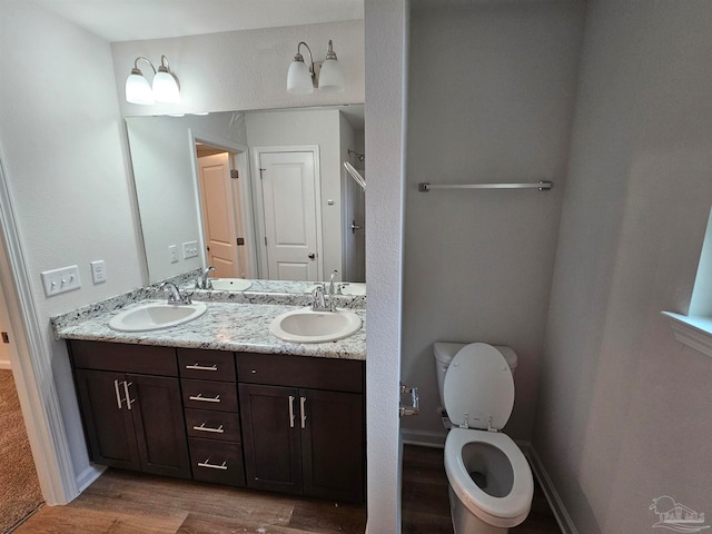 bathroom featuring hardwood / wood-style floors, vanity, and toilet