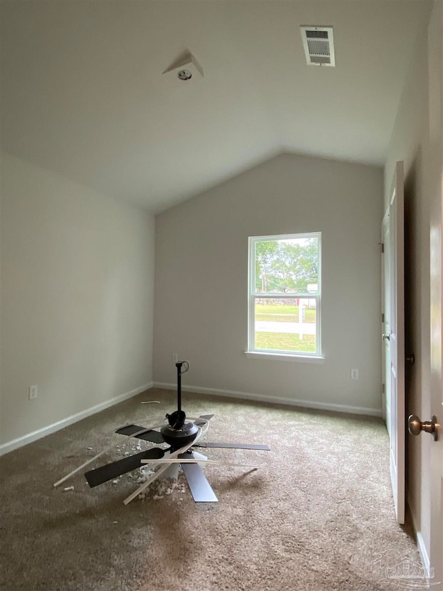 carpeted spare room featuring lofted ceiling and ceiling fan