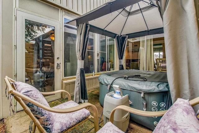 view of patio with a hot tub and a gazebo