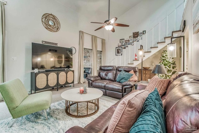 living room with high vaulted ceiling, carpet floors, and ceiling fan