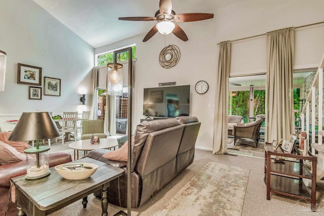 carpeted living room featuring lofted ceiling and ceiling fan