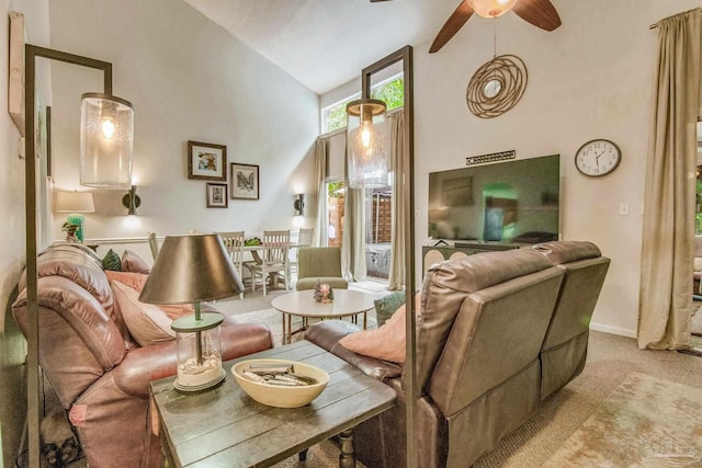 carpeted living room with high vaulted ceiling and ceiling fan