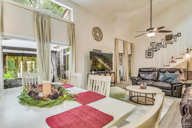 dining space featuring high vaulted ceiling and ceiling fan