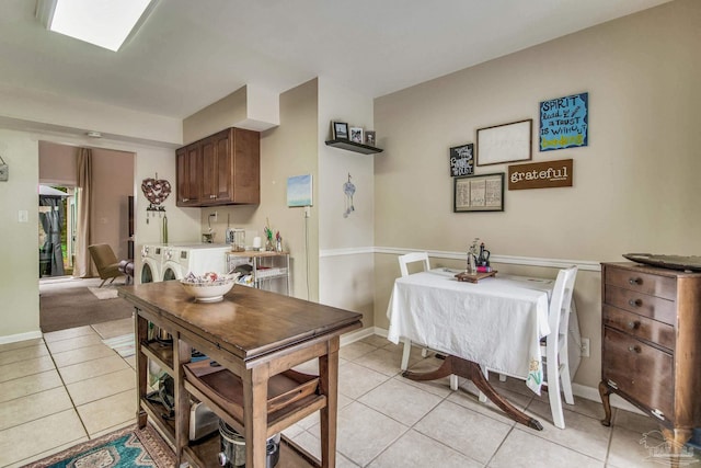 kitchen with washer and dryer and light tile patterned floors